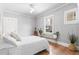 Bright bedroom with a queen bed, hardwood floors, and a window view at 525 N Pearl St, Denver, CO 80203