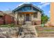 Beautiful bungalow-style home with a classic brick exterior, steps leading up to the covered porch at 525 N Pearl St, Denver, CO 80203