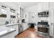 Charming kitchen featuring a cozy breakfast nook, stainless steel appliances, and bright white cabinetry at 525 N Pearl St, Denver, CO 80203
