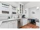 Bright kitchen with white cabinets, stainless appliances, and cozy breakfast nook for modern living at 525 N Pearl St, Denver, CO 80203