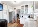 Well-lit kitchen featuring stainless steel appliances, white cabinetry, and hardwood floors for convenience at 525 N Pearl St, Denver, CO 80203