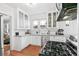 Bright kitchen with white cabinets, stainless appliances and hardwood floors, providing functionality and style at 525 N Pearl St, Denver, CO 80203