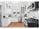 Bright kitchen with white cabinets, stainless appliances, and hardwood floors, perfect for cooking at 525 N Pearl St, Denver, CO 80203