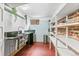 Galley kitchenette with sleek countertops, a mini-fridge, and exposed brick at 525 N Pearl St, Denver, CO 80203