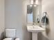 Neutral half-bathroom featuring pedestal sink, modern fixtures, and clean, bright space at 2653 W 69Th Dr, Denver, CO 80221