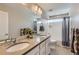 Bright bathroom featuring a double sink vanity, bathtub, and modern fixtures at 2653 W 69Th Dr, Denver, CO 80221