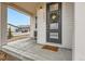 Charming home entrance with a wreath on the front door and covered porch at 2653 W 69Th Dr, Denver, CO 80221