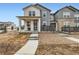 Charming two-story home featuring a welcoming front porch, modern siding, and landscaped front yard at 2653 W 69Th Dr, Denver, CO 80221