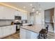 Updated kitchen with a large island, stainless steel appliances, and white cabinets at 2653 W 69Th Dr, Denver, CO 80221