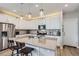 Contemporary kitchen with white cabinets, stainless steel appliances, and an island with bar stools at 2653 W 69Th Dr, Denver, CO 80221