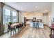 Bright, open kitchen featuring stainless steel appliances, pendant lighting, and a large window at 2653 W 69Th Dr, Denver, CO 80221