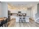 Open concept kitchen and dining area with stainless steel appliances and wood floors at 2653 W 69Th Dr, Denver, CO 80221