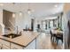 Bright kitchen with an open layout, featuring modern appliances and a view into the living area at 2653 W 69Th Dr, Denver, CO 80221