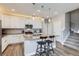 Modern kitchen featuring a central island with bar seating, white cabinetry, and stainless steel appliances at 2653 W 69Th Dr, Denver, CO 80221