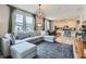 Bright, open living room featuring a comfortable sectional sofa and a view into the kitchen at 2653 W 69Th Dr, Denver, CO 80221