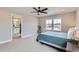Spacious main bedroom with en-suite bathroom, plush carpeting, and natural light at 2653 W 69Th Dr, Denver, CO 80221