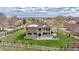 Expansive backyard with white fence, large patio, and well-manicured lawn at 14461 Inca Ct, Westminster, CO 80023