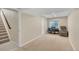 Finished basement with a staircase leading down and a cozy nook with a piano at 14461 Inca Ct, Westminster, CO 80023