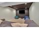 Entertainment area in the basement with a mounted TV and plush seating at 14461 Inca Ct, Westminster, CO 80023