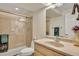 Bright bathroom featuring a glass shower, light wood vanity, and neutral tones at 14461 Inca Ct, Westminster, CO 80023