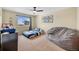 Bright bedroom featuring a window, ceiling fan, and ample space for comfortable living at 14461 Inca Ct, Westminster, CO 80023
