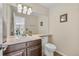 Well-lit powder room features a vanity with a single sink, a toilet, and neutral décor at 14461 Inca Ct, Westminster, CO 80023