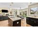 Modern kitchen with island, open layout, and seamless connection to the living area at 14461 Inca Ct, Westminster, CO 80023
