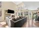 Bright living room with a fireplace, TV and large windows offering great backyard views at 14461 Inca Ct, Westminster, CO 80023