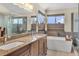 Bright main bathroom with double vanity, soaking tub, and separate glass-enclosed shower at 14461 Inca Ct, Westminster, CO 80023