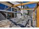 Back porch featuring comfortable seating under a modern wood pergola at 69 Dawn Heath Cir, Littleton, CO 80127