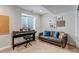 Finished basement featuring a grey sofa and piano perfect for a rec room at 69 Dawn Heath Cir, Littleton, CO 80127