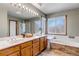 Bathroom features a double vanity, a soaking tub, and a glass-enclosed shower stall at 69 Dawn Heath Cir, Littleton, CO 80127