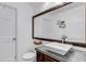 Charming bathroom with a vessel sink, dark-stained wood mirror frame, and modern fixtures at 69 Dawn Heath Cir, Littleton, CO 80127