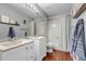 Bathroom featuring a double sink vanity with white cabinets, light grey walls, and updated fixtures at 69 Dawn Heath Cir, Littleton, CO 80127