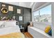 Cozy bedroom with board and batten accent wall, built-in bench, and bright window at 69 Dawn Heath Cir, Littleton, CO 80127