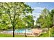 Large community pool with plenty of seating and mature trees providing shade at 69 Dawn Heath Cir, Littleton, CO 80127