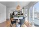 Cozy dining area featuring a modern light fixture and sliding door access to outdoor area at 69 Dawn Heath Cir, Littleton, CO 80127