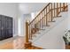 Elegant entryway featuring wood floors, staircase, and a stylish front door at 69 Dawn Heath Cir, Littleton, CO 80127