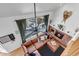 Bright living room with vaulted ceilings, a brick fireplace, and a large sectional sofa at 69 Dawn Heath Cir, Littleton, CO 80127