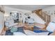 Bright and airy living room featuring modern decor, a wooden staircase, and an open layout at 69 Dawn Heath Cir, Littleton, CO 80127