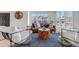 Sunlit living room with stylish furnishings, including a leather sofa and patterned rug at 69 Dawn Heath Cir, Littleton, CO 80127