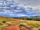 Scenic landscape view of Colorado neighborhood with a cloudy sky backdrop on a hiking trail at 69 Dawn Heath Cir, Littleton, CO 80127