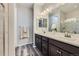 Bathroom featuring double sinks, modern fixtures, and a glass-enclosed shower at 18187 E 99Th Ave, Commerce City, CO 80022