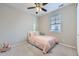 Bright bedroom featuring a ceiling fan, window with blinds, and soft, carpeted floors at 18187 E 99Th Ave, Commerce City, CO 80022