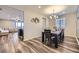 Bright dining room featuring stylish wood flooring and a view into the next living space at 18187 E 99Th Ave, Commerce City, CO 80022