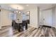 Bright dining room featuring stylish wood flooring, a modern chandelier, and a large dining table at 18187 E 99Th Ave, Commerce City, CO 80022