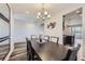 Bright dining room featuring stylish wood flooring and a view into the next living space at 18187 E 99Th Ave, Commerce City, CO 80022