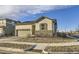 Inviting single Gathering home with stone accents, siding, a two-car garage and manicured landscaping at 18187 E 99Th Ave, Commerce City, CO 80022