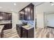 Modern kitchen featuring dark cabinetry, stainless steel appliances, and a stylish backsplash at 18187 E 99Th Ave, Commerce City, CO 80022