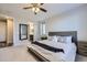 Serene main bedroom with soft carpet, a ceiling fan, and an ensuite bathroom entrance at 18187 E 99Th Ave, Commerce City, CO 80022